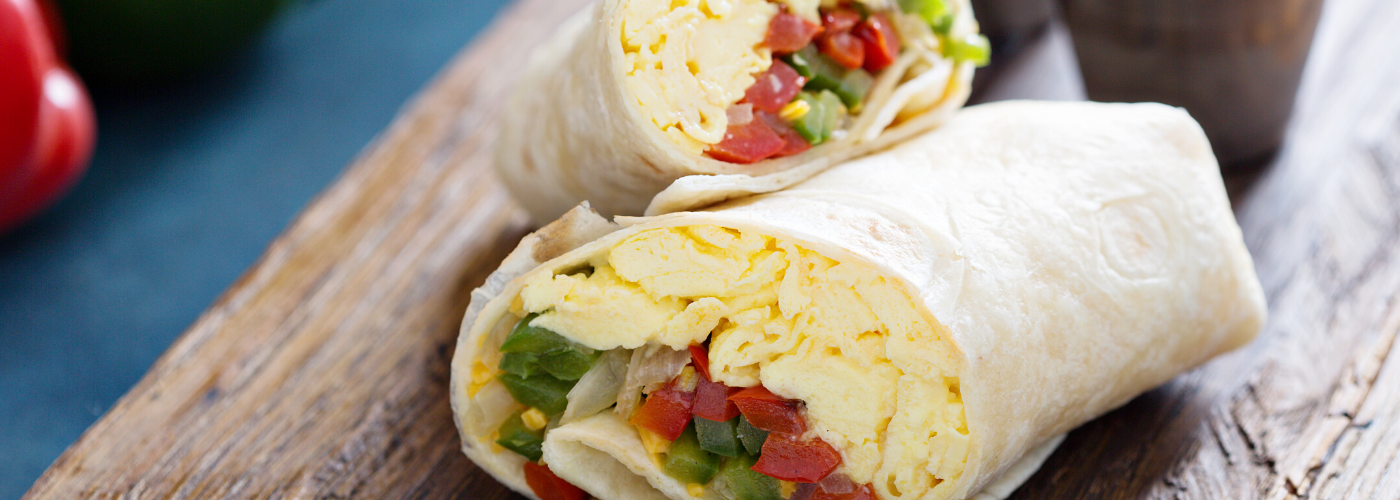 Breakfast burritos on wooden table