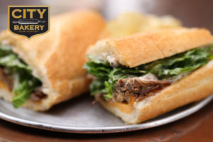 City Bakery logo on picture of roast beef sub