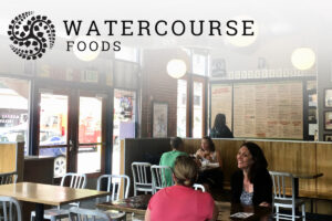 Watercourse Foods name and logo on picture of two woman eating at SubCulture